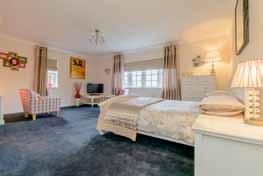 A further staircase takes you to the second floor where there is a large bedroom with dressing area and en suite bathroom and