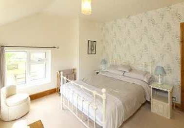 radiator, fully tiled walls, ceiling beam, loft access point, fitted daylight tube. BEDROOM TWO 3.73m max x 3.35m (12'3" max x 11'0") Window to the front having lovely countryside views, radiator.