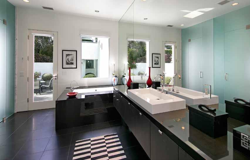 The ocean view master bathroom enjoys large floating black granite countertop with a glass bowl sink, and a large walk-in shower, a skylight, and a