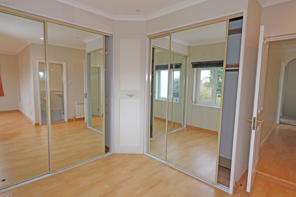 Master Bedroom Dressing Area 10 2 x 7 6 Fitted with four mirror fronted wardrobes and a