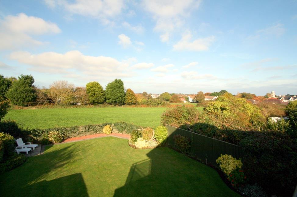 The west facing garden is beautifully kept and comprises a wide lawn bounded by mature hedging and