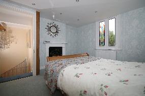 ceiling, door leads out to:- FITTED CLOAKROOM: Obscure window to the side, being part tiled,