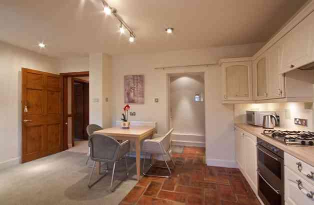 The immediately impressive lounge with double doors to the rear garden flood the room with light and provides a fantastic focal
