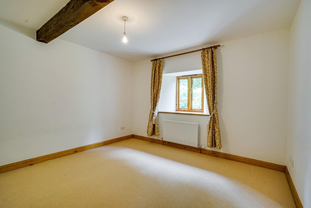 43m) a spacious double room with exposed wooden beam, double glazed window with splendid views over the valley towards Whitbarrow and surrounding fields and woodland and 2 steps down to:- En-Suite