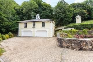 To the rear, steps lead up to a small paddock and an impressive dovecote with entrance and store room to the ground floor.