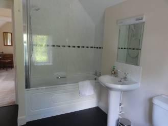 Light/shaver socket above mirror. Electric towel rail. Electric wall heater.