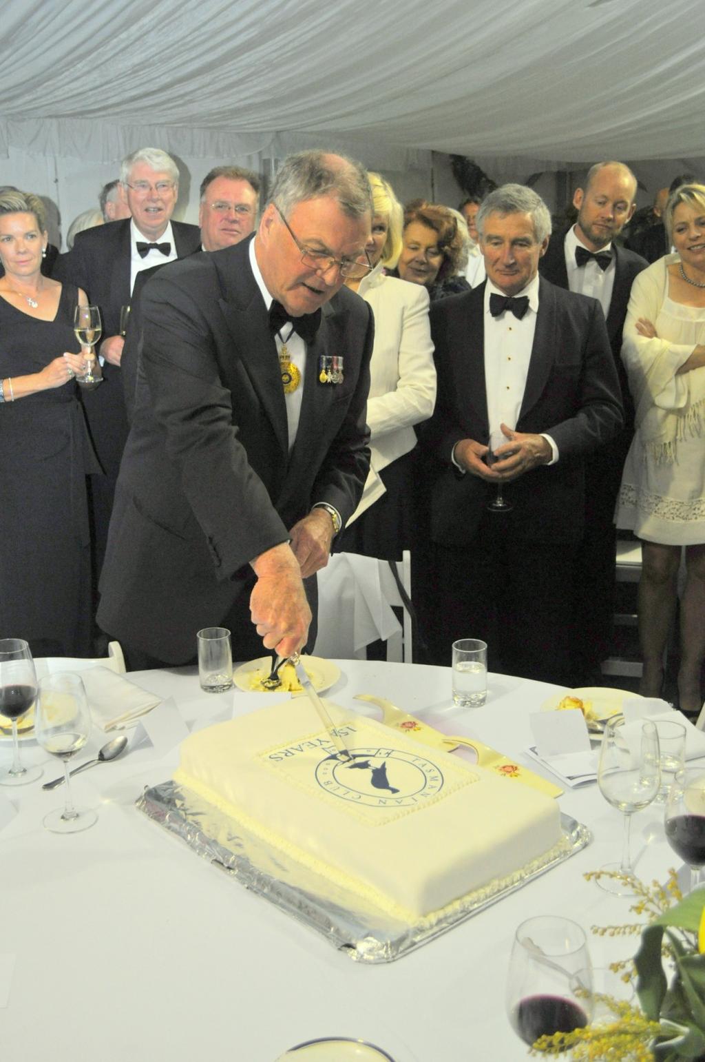 Excellency The Governor, the Hon Peter Underwood, cuts the Tasmanian Club s 150th birthday cake