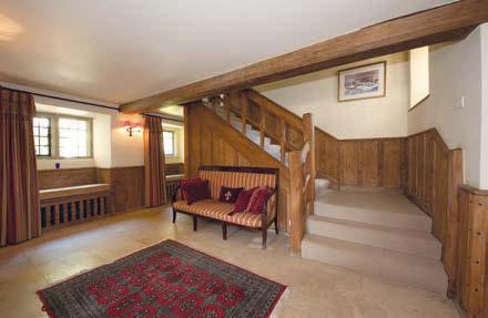 u Drawing room, a spacious reception room within the oldest part of the house with exposed beams, large open fireplace, charming former wig cupboard with Jacobean door and original front door to