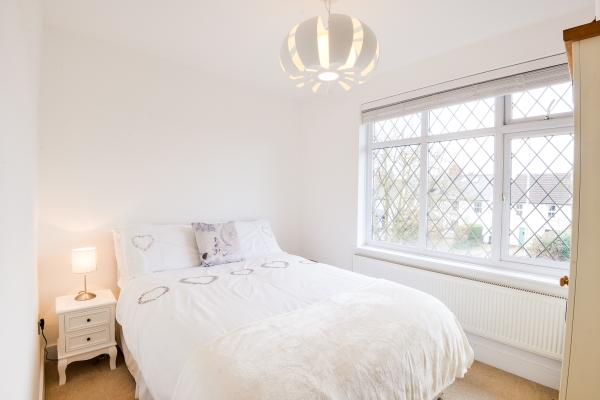 92m(14'5" x 9'7") A spacious double bedroom with a range of built in mirror-fronted wardrobes, dual aspect UPVC double glazed windows to front and rear, radiator, laminate flooring, doorway