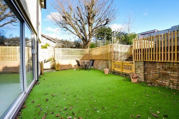 Directly to the rear of the property there is a gated patio area with supporting wall and steps up the remainder of the garden.