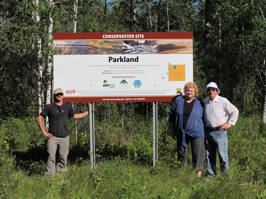 Photo Captions Alberta Conservation Association staff member Marco Fontana and volunteers installing signage at the