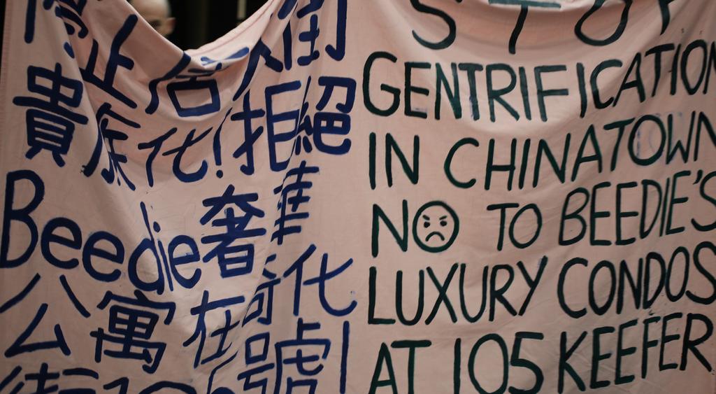 BEEDIE LIVING CONTINUES TO BULLDOZE OVER VOICES OF CHINATOWN COMMUNITY Organizers and supporters carried a banner reading, Stop gentrification in Chinatown.