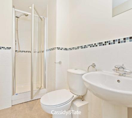 Carpet. Cloakroom Suite comprises: Wash hand basin in vanity unit. Low level WC. Radiator. Extractor fan.