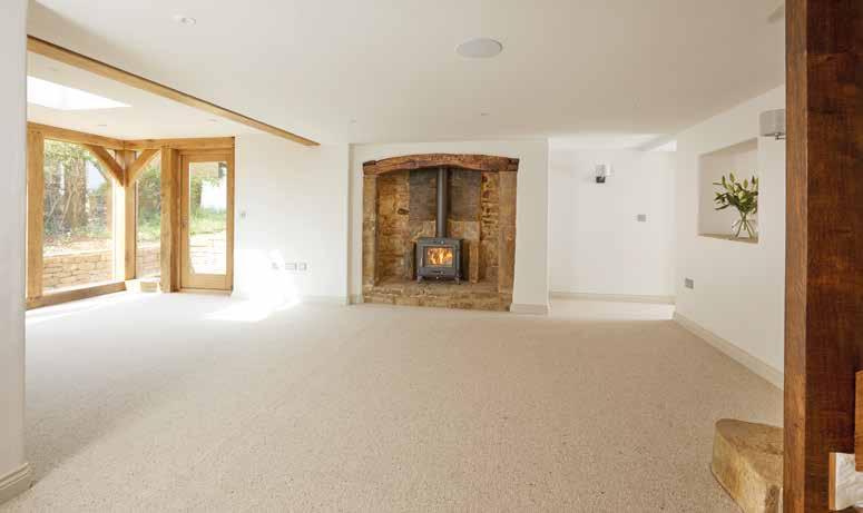Flowing through a well-lit formal dining room with oak framed glass panels, bi-folding doors to rear terrace and exposed stone wall you reach the sitting room, the heart of the old cottage with