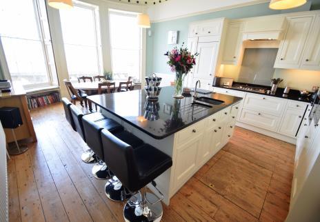 The kitchen / dining room is equally impressive with a sumptuous shaker style fitted kitchen with granite work surfaces and matching central island, original stripped floorboards and dining area