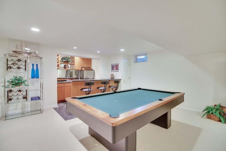 It s the ideal place for entertaining, as it features a full service wet bar sink and refrigerator a three stool counter