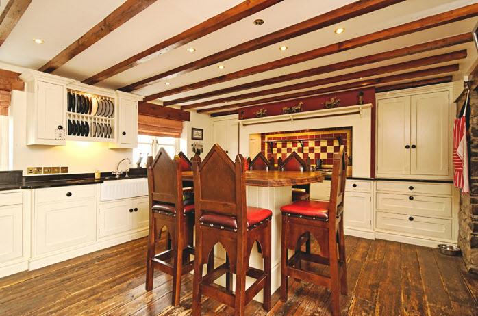 island unit/dining table, granite work tops, beamed ceiling, part tiled walls, Guinness board reclaimed oak strip flooring. UTILITY ROOM: 18'.0" x 9'.