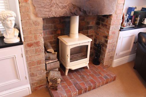 Modern stylish fireplace with open coal effect freestanding gas fire and grate. TV aerial point. Radiator.