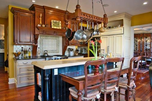 Granite counters give way to a tile backsplash while the center island with marble