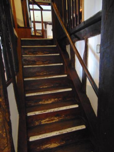 The wooden staircase has 9 steps with a handrail to the right.