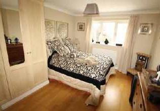 En-suite With a window to the side, panelled bath with mixer taps and shower head,