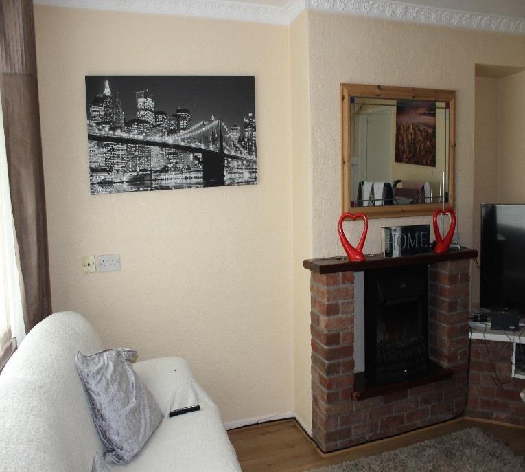 Ground floor comprises sitting room with brick surround fireplace, open