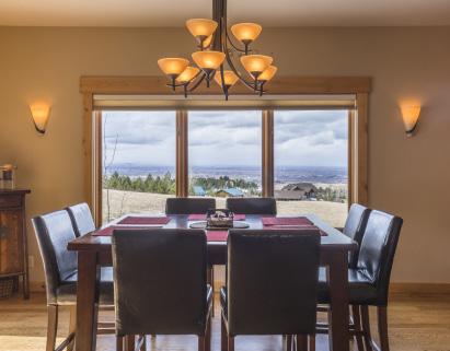 With glass doors leading to the south facing entertaining deck, the dining area bridges the kitchen and living room.