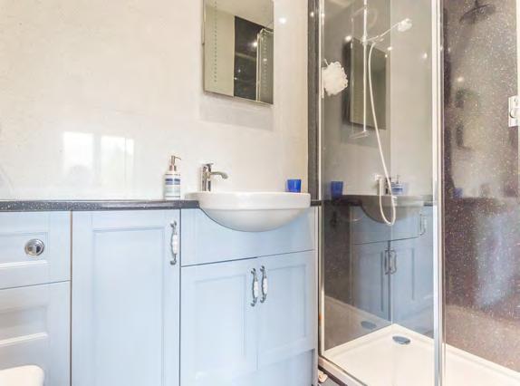 5 sink unit with mixer tap, tiled splashbacks, space for a dishwasher, eye level oven, 4 ring hob and extractor hood above, space for a large dining table and chairs and two windows with views to the