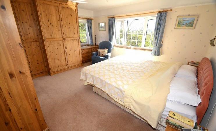 Bedroom 1 14'10 x 13'9 (4.52m x 4.19m) Windows to side and rear. Fitted pine wardrobes and drawer unit.