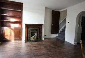 47m) Lounge with windows to front elevation, featuring built in storage units with draws, original fire