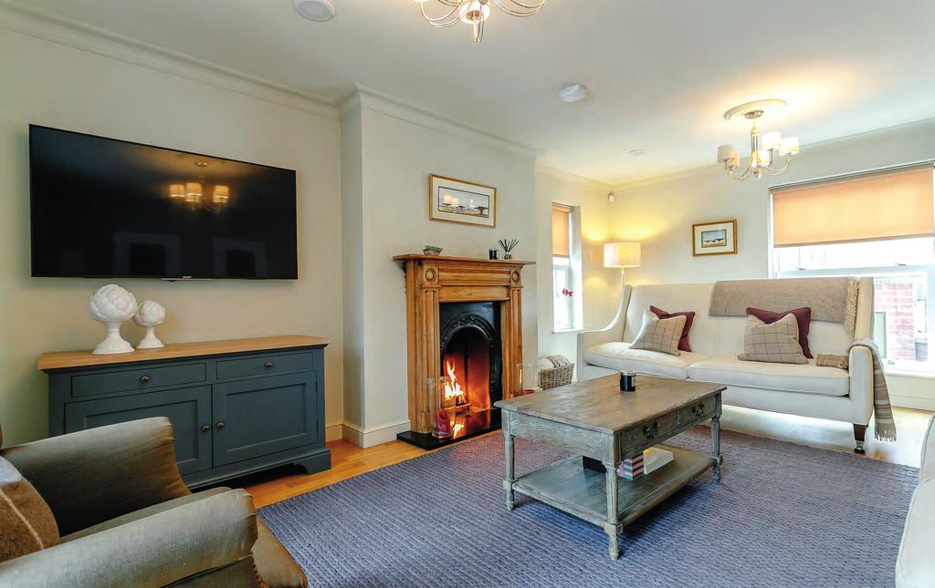 The elegant sitting room features a quite stunning fireplace and is a room for all seasons, whether it