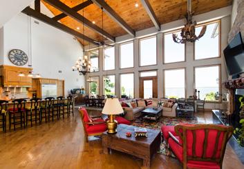 With a lake view and pool access, the highlight of the spacious game room is a 15-foot long granite bar, complete with a professional