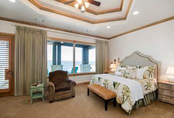 Wake up to a lake view from the master suite. The master bedroom has a trey ceiling, 64 television, and a full-length, north-facing covered patio for an amazing view from the bed.