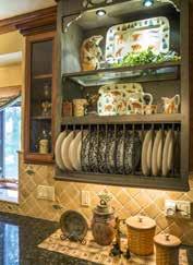 The cherry wood custom cabinetry includes an old-fashion plate display rack.