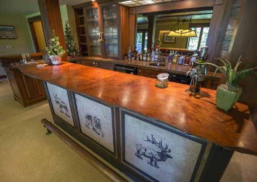 glass-fronted double-door cabinets, furniture-style cabinetry, a copper bar sink, wine