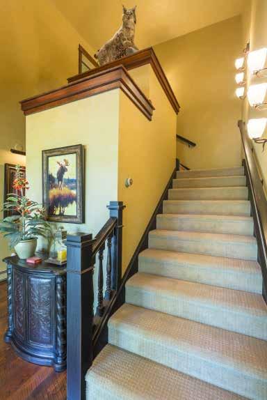 Stairs lead to the second upper-level space, featuring a powder room, and the attached three-car heated garage.