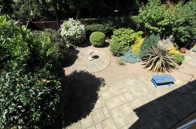 REAR GARDEN An attractive low maintenance rear garden with a variety of mature inset plants and shrubs.