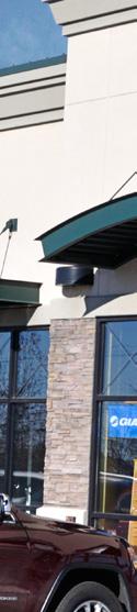 Painted, stucco siding with cultured stone; metal awnings. Aluminum window and door frames.