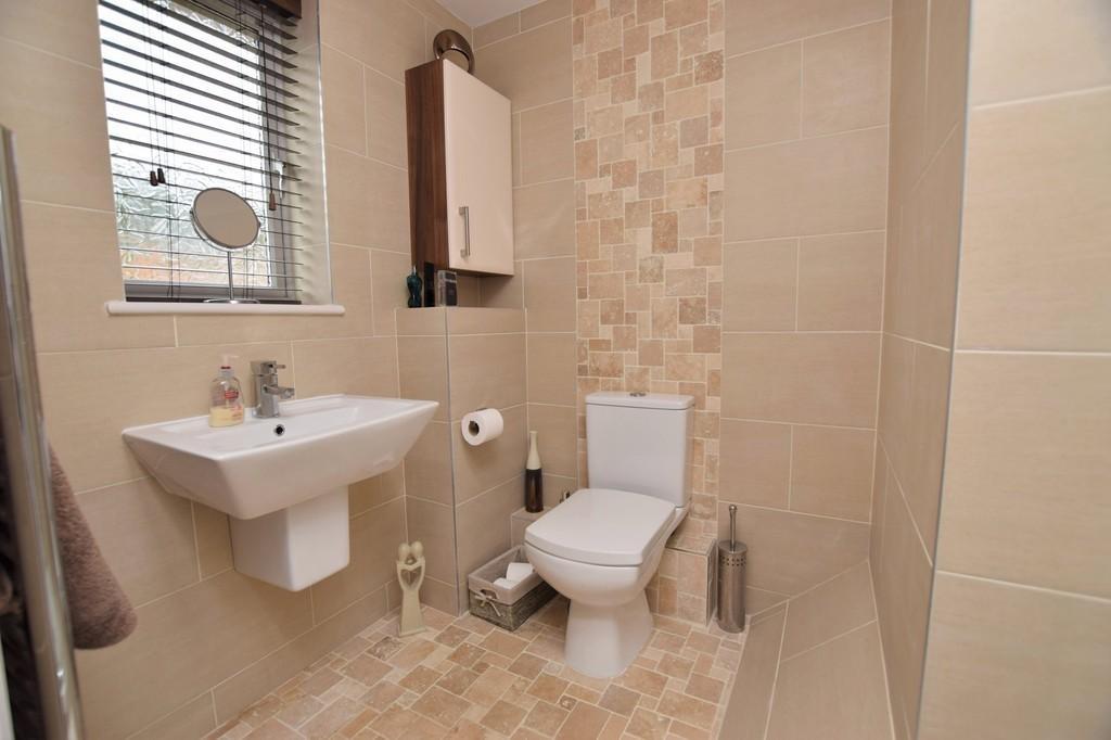 71m) A modern suite finished with attracive tiled walls nad flooring, panel bath with thermostatic shower, glazed scree, close couple WC, half pedestal wash basin, chrome towel radiator, upvc double