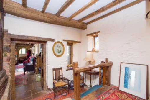 There are separate dining and kitchen areas within this room, with room for a breakfast table at the kitchen end. The floor throughout is stone flagging, exposed painted stone walls.