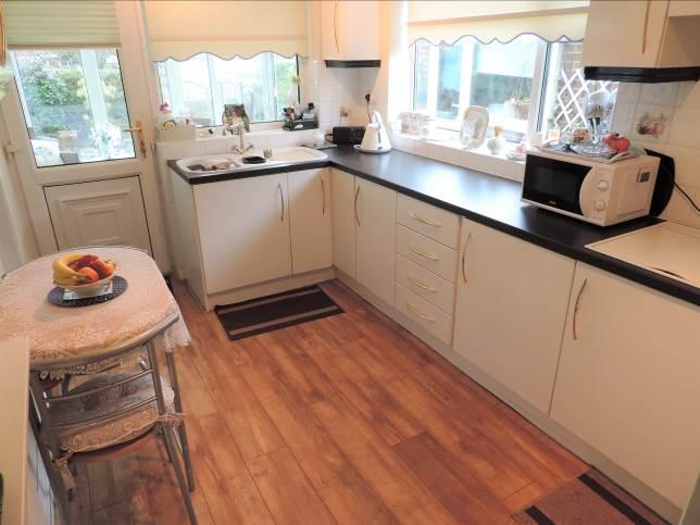 Kitchen: 13 01 x 8 00 Fitted with a range of wall and base units with worktops,