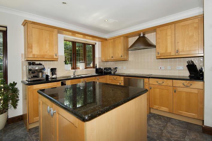 integrated appliances and granite work surfaces, plus a separate cloakroom and utility room.