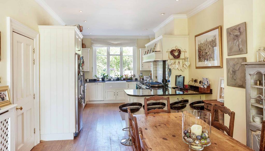 The impressive kitchen/dining room/drawing room is an excellent large open plan room with an extensive range of solid wood cupboards and drawers set beneath long granite work tops with matching