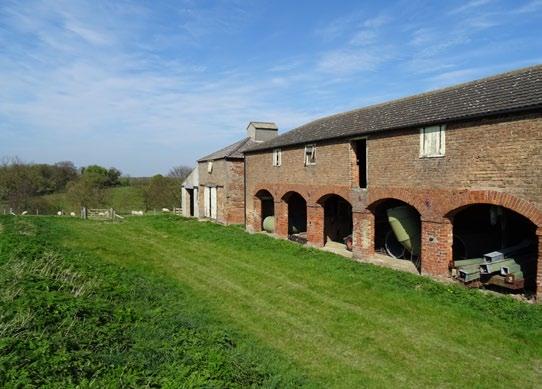 In addition, the most northerly part of this range includes a grain bin store and reception pit and the buildings have the benefit of attractive architectural features including a series of arches