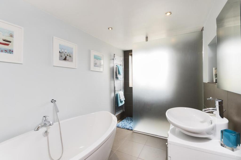 En-suite Bathroom: Velux window, Double ended Paneled bath with tiled surround, Pedestal wash hand basin, Low level WC. Chrome Ladder style radiator.