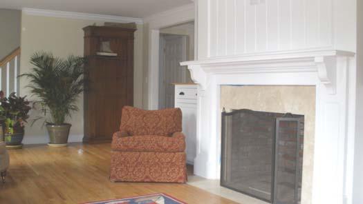 foot room with abundant light through six over six style windows Brick lined gas fireplace with black honed marble hearth and trim Coffered ceiling with 6 inch tongue in groove