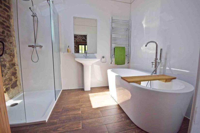 Beautifully fitted with a white suite comprising a large double sized shower cubicle with part exposed stone walling, part white