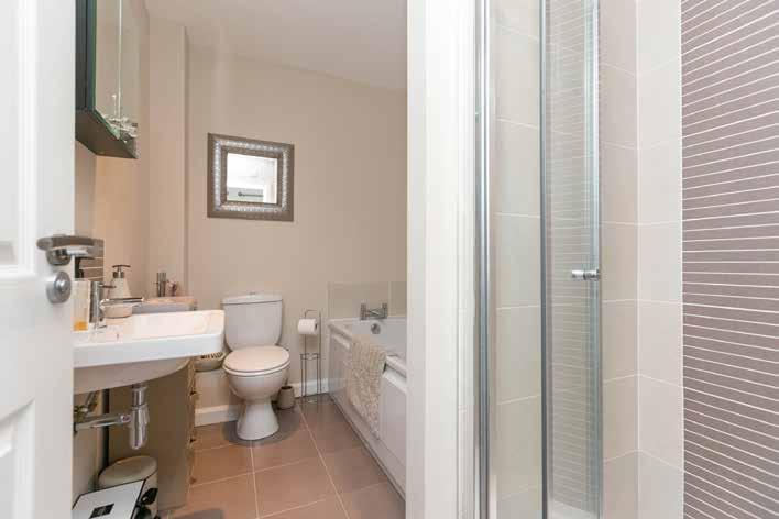 BATHROOM: White suite comprising of panel bath