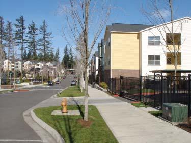 When individual garages are incorporated into projects, common driveways or alley-loaded access is encouraged. Example of garages in a multi-family project. (Orenco Station, Hillsboro, Oregon) 2.