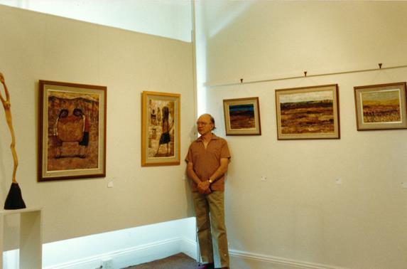 Edin Currie-Wood at his exhibition at Gallery 21, viewing a sculpture by Lucas Sithole - LS8312 GROUP SHOWS From 1951 in the UK and South Africa, including: Adler Fielding Galleries, Johannesburg